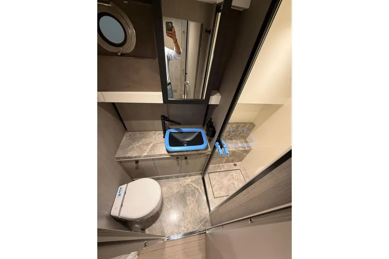 Slide: The Image of Bathroom interior of 2026 Cranchi A46 Luxury Tender with modern fixtures and marble accents. - 22