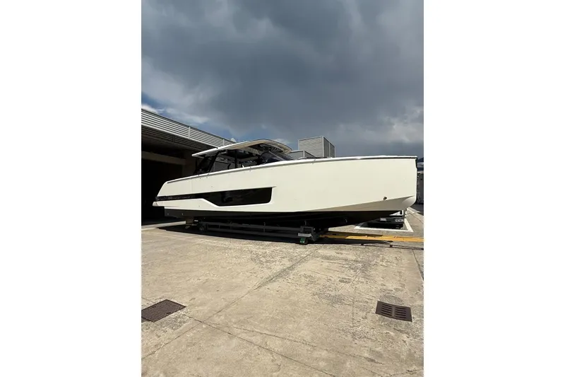 Slide: The Image of 2026 Cranchi A46 Luxury Tender yacht on dry dock under cloudy sky. - 8