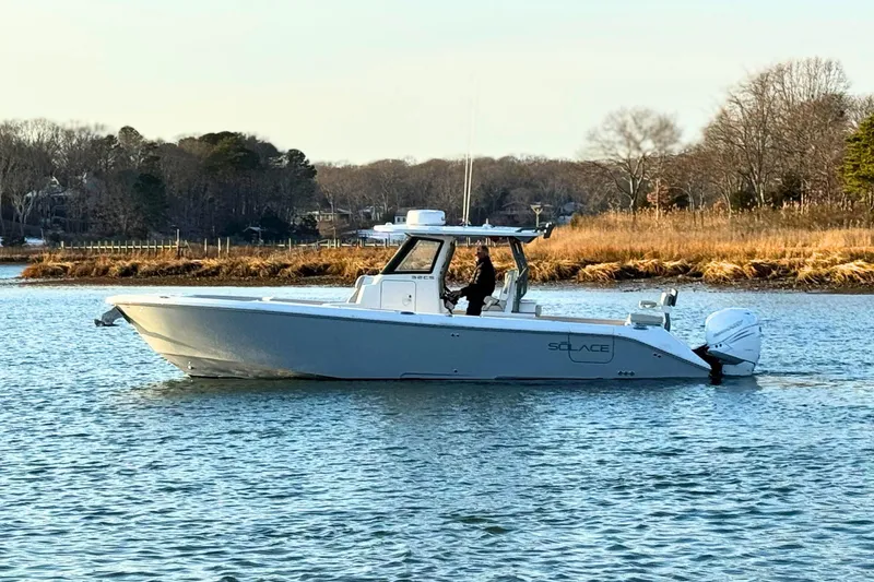 Slide: The Image of 2023 Solace 32 CS boat cruising on open ocean waters. - 1