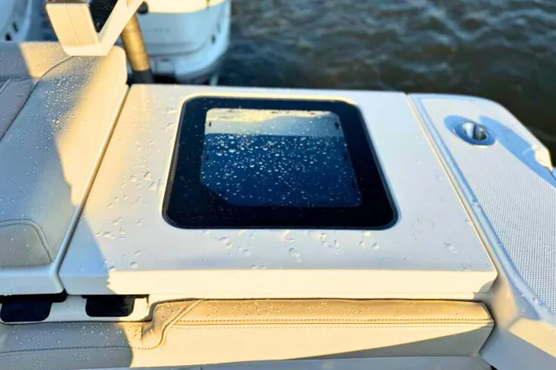 Slide: The Image of Open hatch on 2023 Solace 32 CS boat, revealing storage compartment. - 21