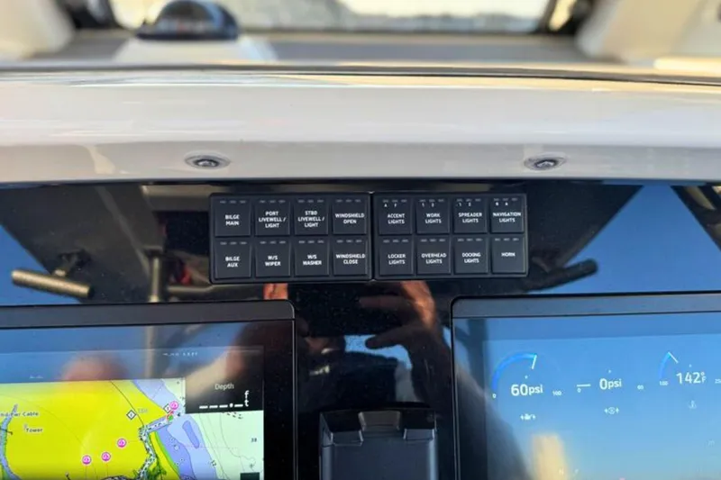 Slide: The Image of Steering wheel of 2023 Solace 32 CS boat with modern controls and navigation display. - 34