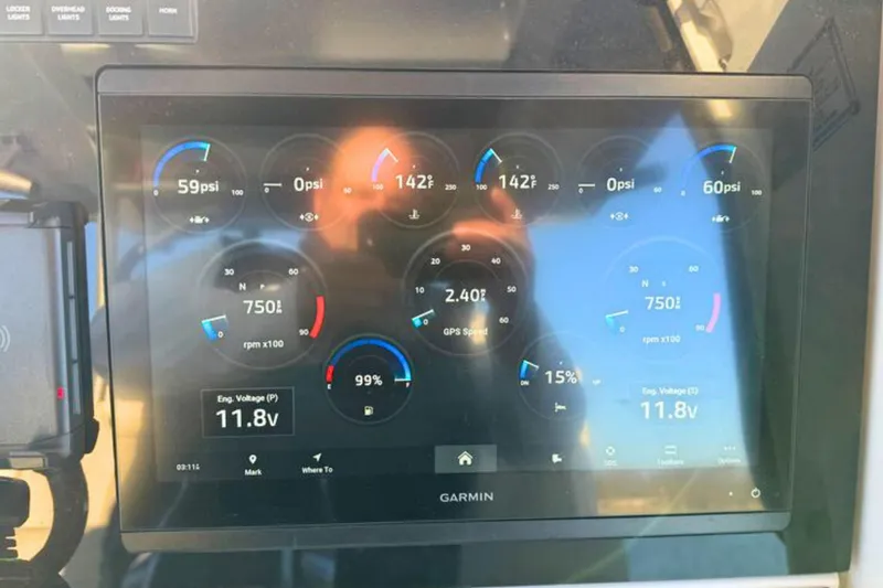 Slide: The Image of Control panel of 2023 Solace 32 CS boat with throttle and warning label. - 35