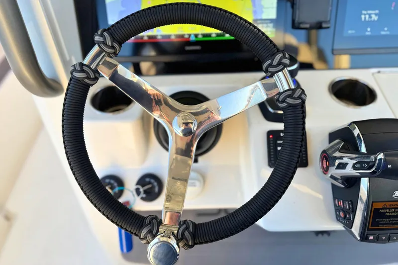 Slide: The Image of 2023 Solace 32 CS boat control panel with Skyhook joystick and Lenco trim tab switches. - 36