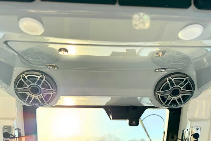 Slide: The Image of Red control switches on a 2023 Solace 32 CS boat dashboard. - 43