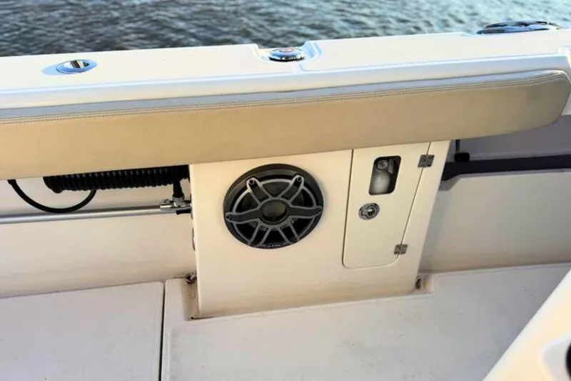 Slide: The Image of 2023 Solace 32 CS boat, sleek design, close-up view, docked on water. - 50