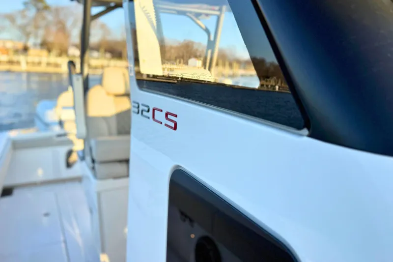 Slide: The Image of 2023 Solace 32 CS boat interior with compact bathroom and wooden cabinetry. - 52