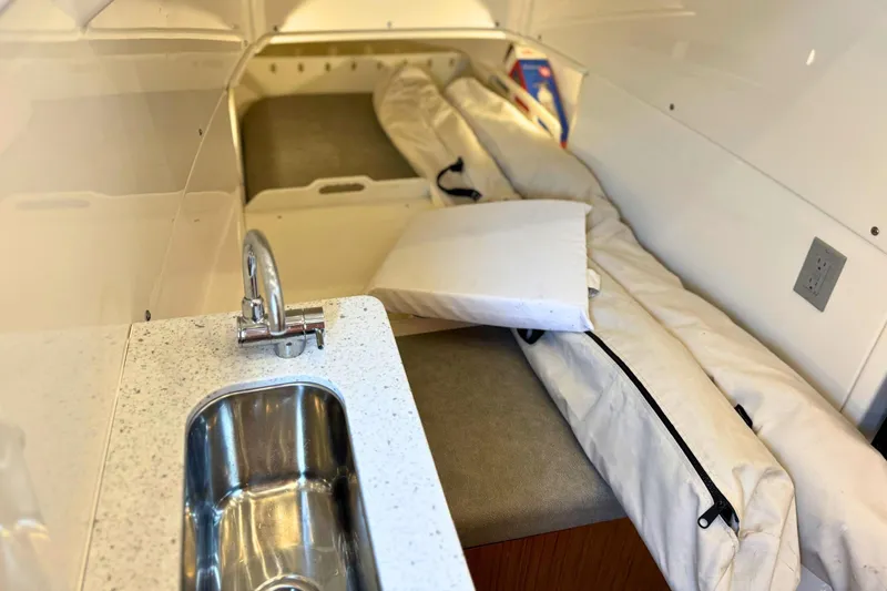 Slide: The Image of Luxurious seating area on 2023 Solace 32 CS boat with table and quilted cushions. - 56