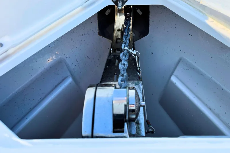 Slide: The Image of 2023 Solace 32 CS boat storage compartment, open and empty, showcasing interior space. - 61