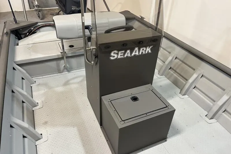 Slide: The Image of 2025 SeaArk 2472 CUB boat interior with steering console and seating. - 10