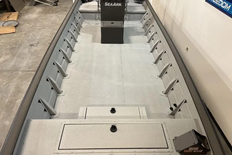 Slide: The Image of 2025 SeaArk 2472 CUB boat interior with spacious deck and storage compartments. - 12