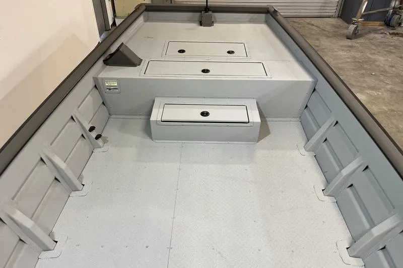 Slide: The Image of 2025 SeaArk 2472 CUB boat interior with storage compartments, gray finish. - 13