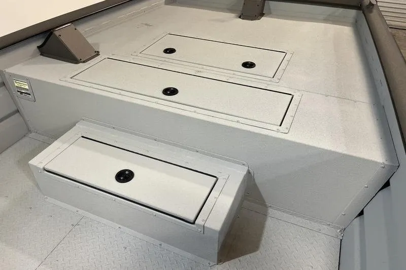 Slide: The Image of 2025 SeaArk 2472 CUB boat interior with storage compartments and non-slip flooring. - 14