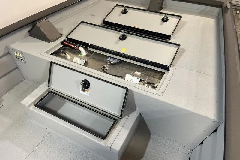 Slide: The Image of 2025 SeaArk 2472 CUB boat interior with open storage compartments. - 15