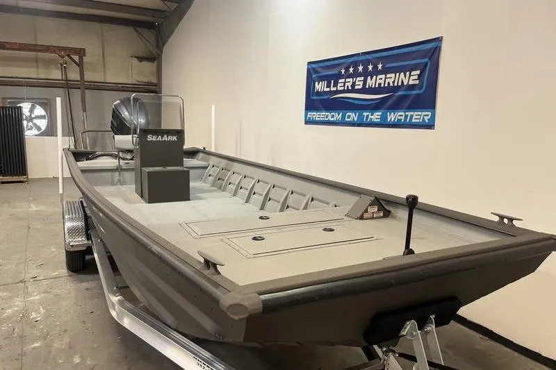 Slide: The Image of 2025 SeaArk 2472 CUB boat displayed at Miller's Marine showroom. - 2