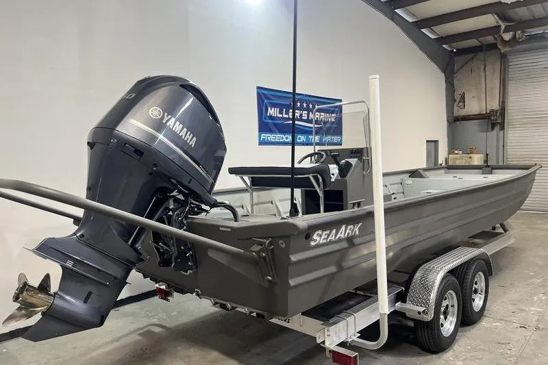 Slide: The Image of 2025 SeaArk 2472 CUB boat with Yamaha motor on trailer in a garage. - 3