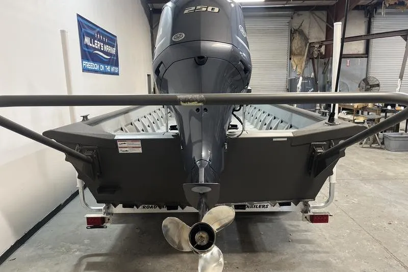 Slide: The Image of 2025 SeaArk 2472 CUB boat with powerful 250 engine in a workshop setting. - 4