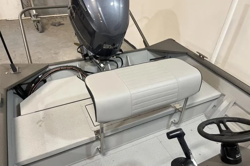 Slide: The Image of 2025 SeaArk 2472 CUB boat interior with motor and steering wheel. - 5