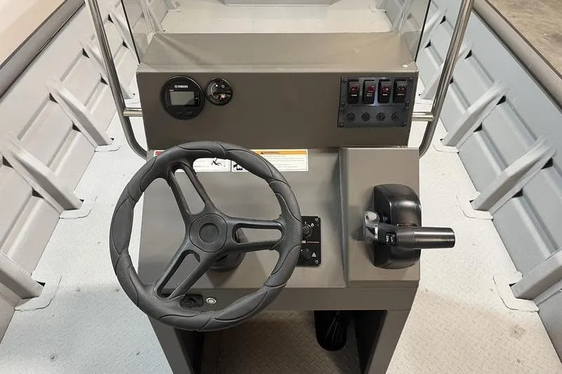 Slide: The Image of Steering console of 2025 SeaArk 2472 CUB boat with controls and gauges. - 7