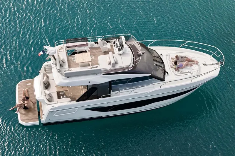 Slide: The Image of Manufacturer Provided Image: Luxury 2026 Prestige F4.3 yacht cruising on clear blue waters, with people relaxing onboard. - 3