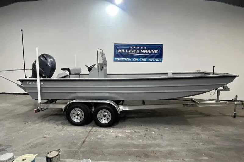 Slide: The Image of 2025 SeaArk 2072 CUB boat on trailer in showroom, Miller's Marine banner visible. - 0