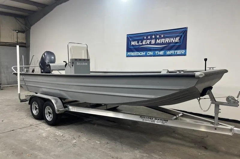 Slide: The Image of 2025 SeaArk 2072 CUB boat on trailer in showroom, Miller's Marine banner visible. - 1