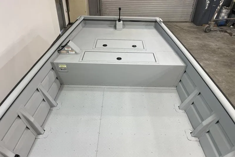 Slide: The Image of 2025 SeaArk 2072 CUB boat interior with storage compartments and control lever. - 11