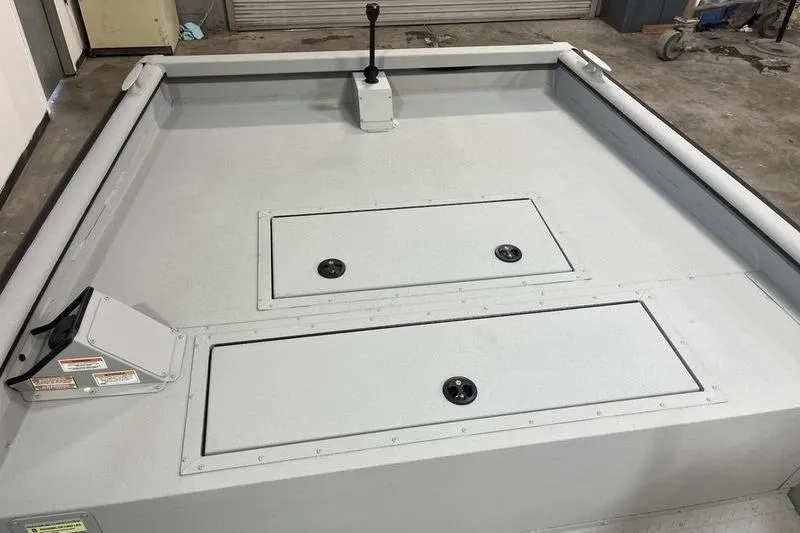 Slide: The Image of 2025 SeaArk 2072 CUB boat interior with storage compartments and control lever. - 12