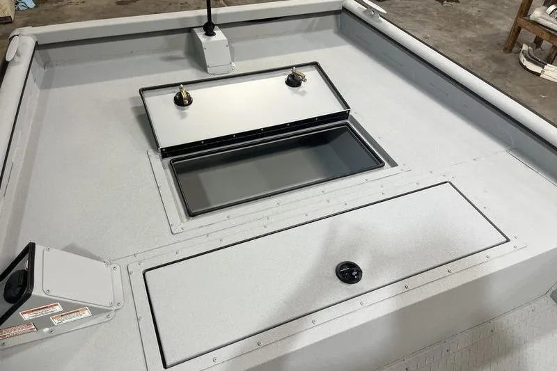 Slide: The Image of 2025 SeaArk 2072 CUB boat deck with storage compartments and fishing rod holders. - 13