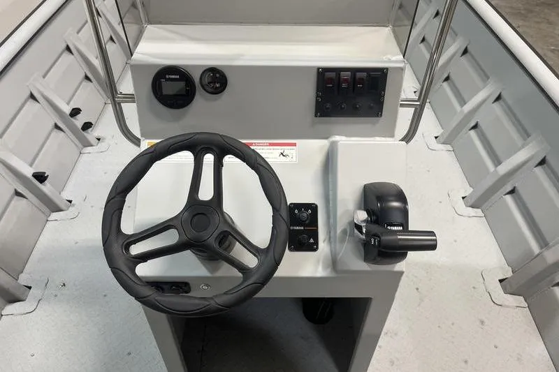Slide: The Image of Steering console of 2025 SeaArk 2072 CUB boat with controls and gauges. - 6