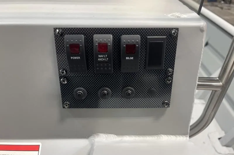 Slide: The Image of Control panel of 2025 SeaArk 2072 CUB boat with switches for power, navigation, and bilge. - 8
