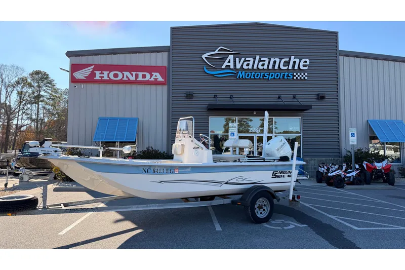 Slide: The Image of 2018 Carolina Skiff 18 JVX CC boat on trailer at Avalanche Motorsports dealership. - 0