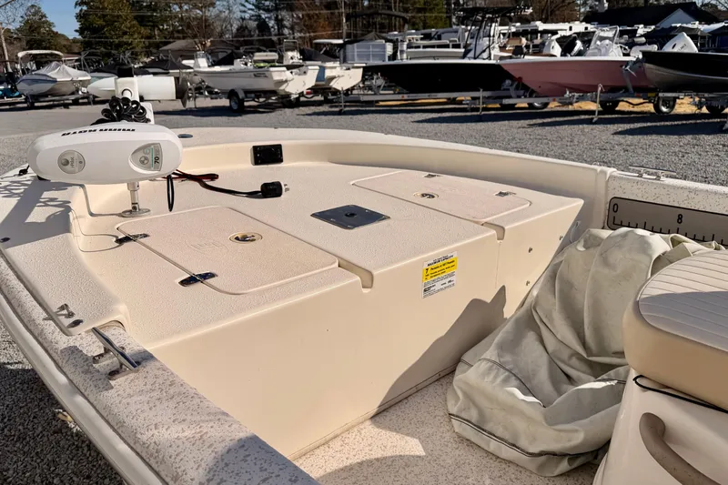 Slide: The Image of 2018 Carolina Skiff 18 JVX CC boat deck with storage compartments and trolling motor. - 5