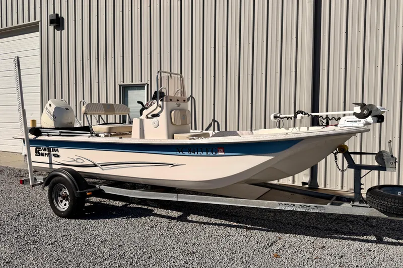 Slide: The Image of 2018 Carolina Skiff 18 JVX CC boat on trailer outside building. - 6