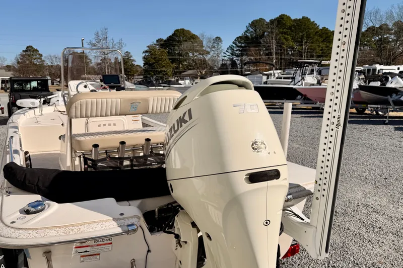 Slide: The Image of 2018 Carolina Skiff 18 JVX CC boat with Suzuki 70 outboard motor in a marina setting. - 8