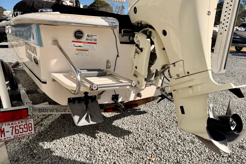 Slide: The Image of 2018 Carolina Skiff 18 JVX CC boat on trailer, rear view with motor. - 9