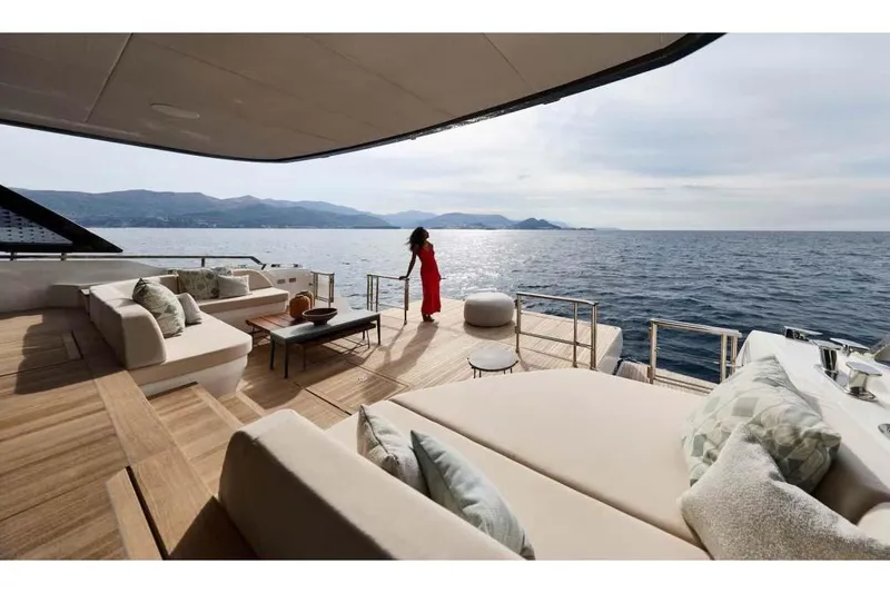 Slide: The Image of Manufacturer Provided Image: Luxurious Prestige M7 yacht deck with ocean view, featuring elegant seating and a person in red. - 2