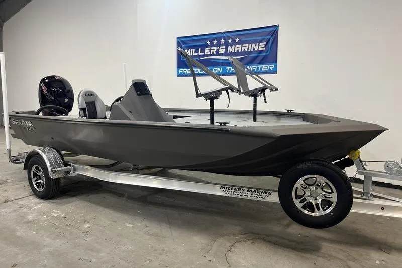 Slide: The Image of 2026 SeaArk Flex 19 Pro boat on trailer at Miller's Marine showroom. - 1