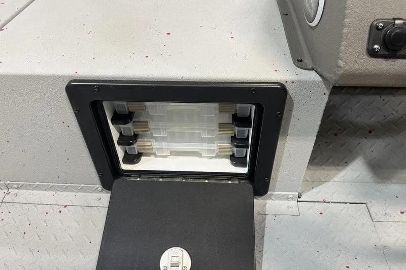 Slide: The Image of 2026 SeaArk Flex 19 Pro storage compartment with organized tackle boxes. - 12