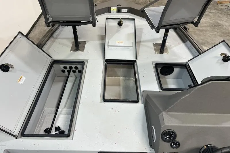 Slide: The Image of 2026 SeaArk Flex 19 Pro boat interior with open storage compartments and seating. - 16