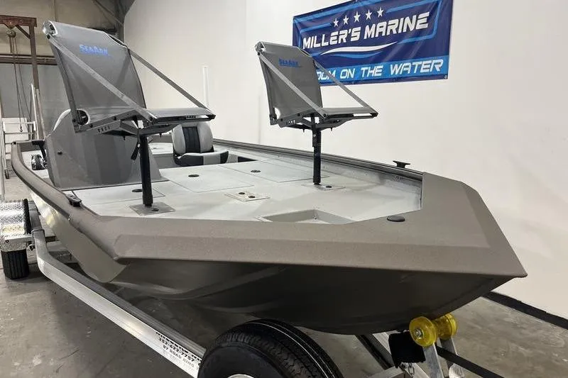 Slide: The Image of 2026 SeaArk Flex 19 Pro boat displayed at Miller's Marine showroom. - 2