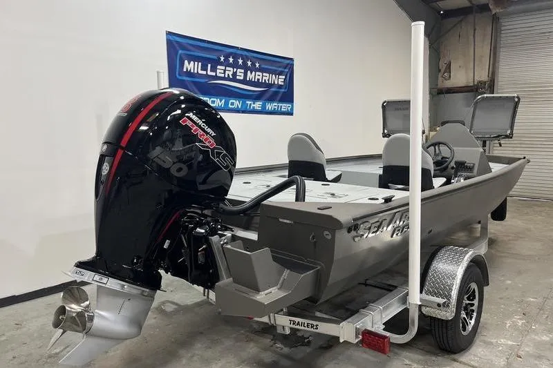 Slide: The Image of 2026 SeaArk Flex 19 Pro boat with powerful outboard motor in showroom. - 3