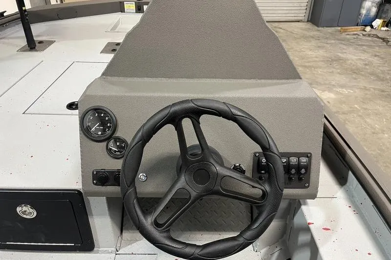 Slide: The Image of Steering console of 2026 SeaArk Flex 19 Pro boat, featuring gauges and controls. - 9