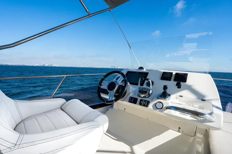 Slide: The Image of Prestige 420 yacht helm, 2020 model, with ocean view and clear blue sky. - 18