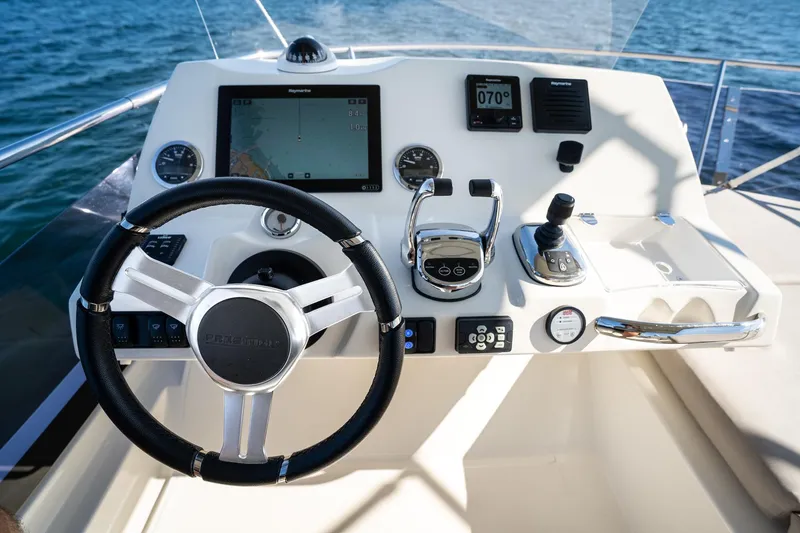 Slide: The Image of Prestige 420 yacht helm, 2020 model, featuring advanced navigation controls and steering wheel. - 19