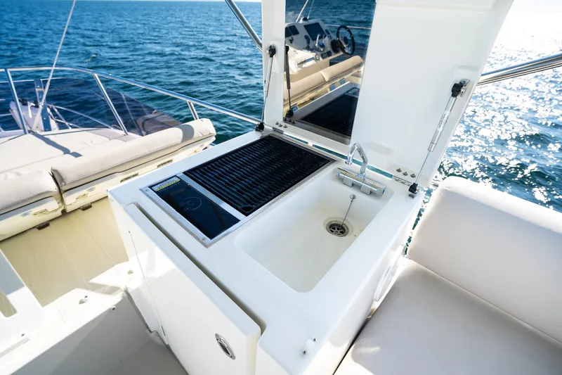 Slide: The Image of Prestige 420 yacht outdoor kitchen with sink and grill, 2020 model, on open water. - 20