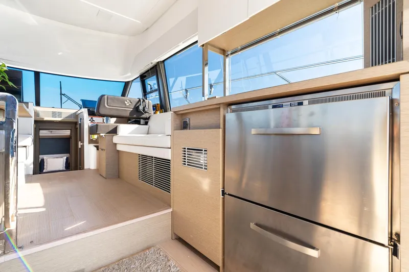 Slide: The Image of Interior of 2020 Prestige 420 yacht with modern kitchen and seating area. - 24