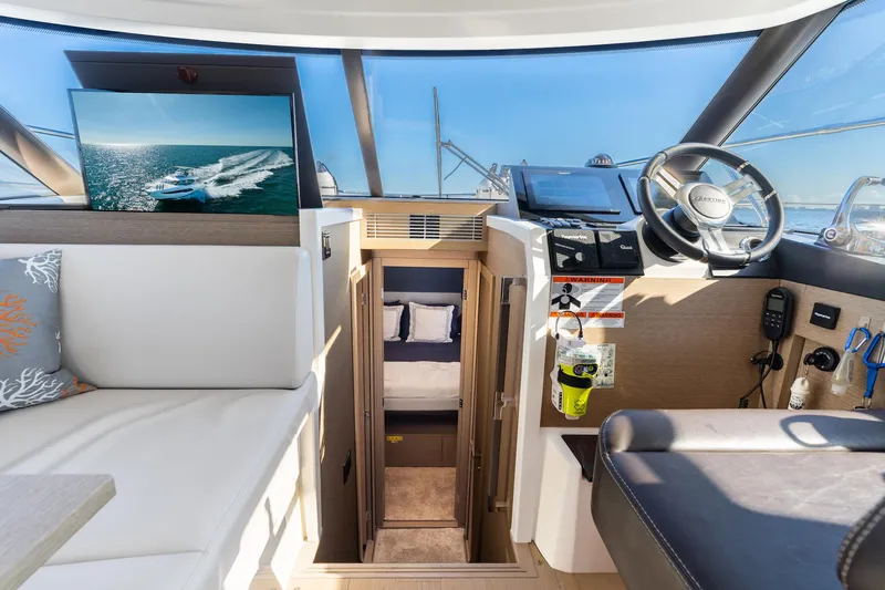 Slide: The Image of Prestige 420 yacht interior, 2020 model, featuring helm and cabin entrance. - 25