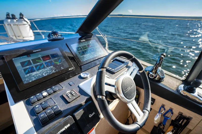 Slide: The Image of Prestige 420 yacht helm with modern controls and ocean view, 2020 model. - 28