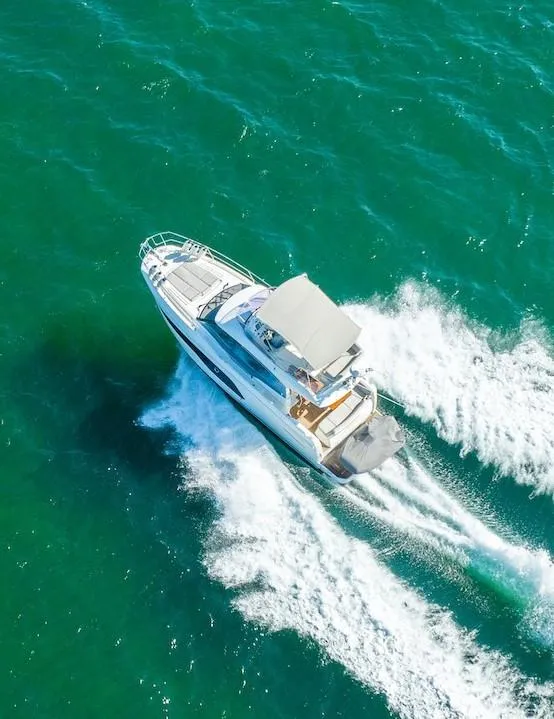 Slide: The Image of Aerial view of 2020 Prestige 420 yacht cruising on turquoise waters. - 4