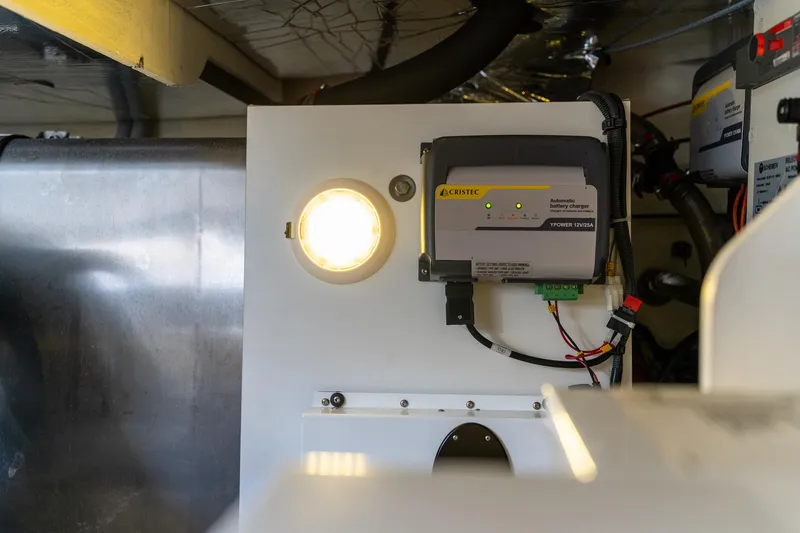 Slide: The Image of Engine room of a 2020 Prestige 420 yacht with electrical components and lighting. - 48